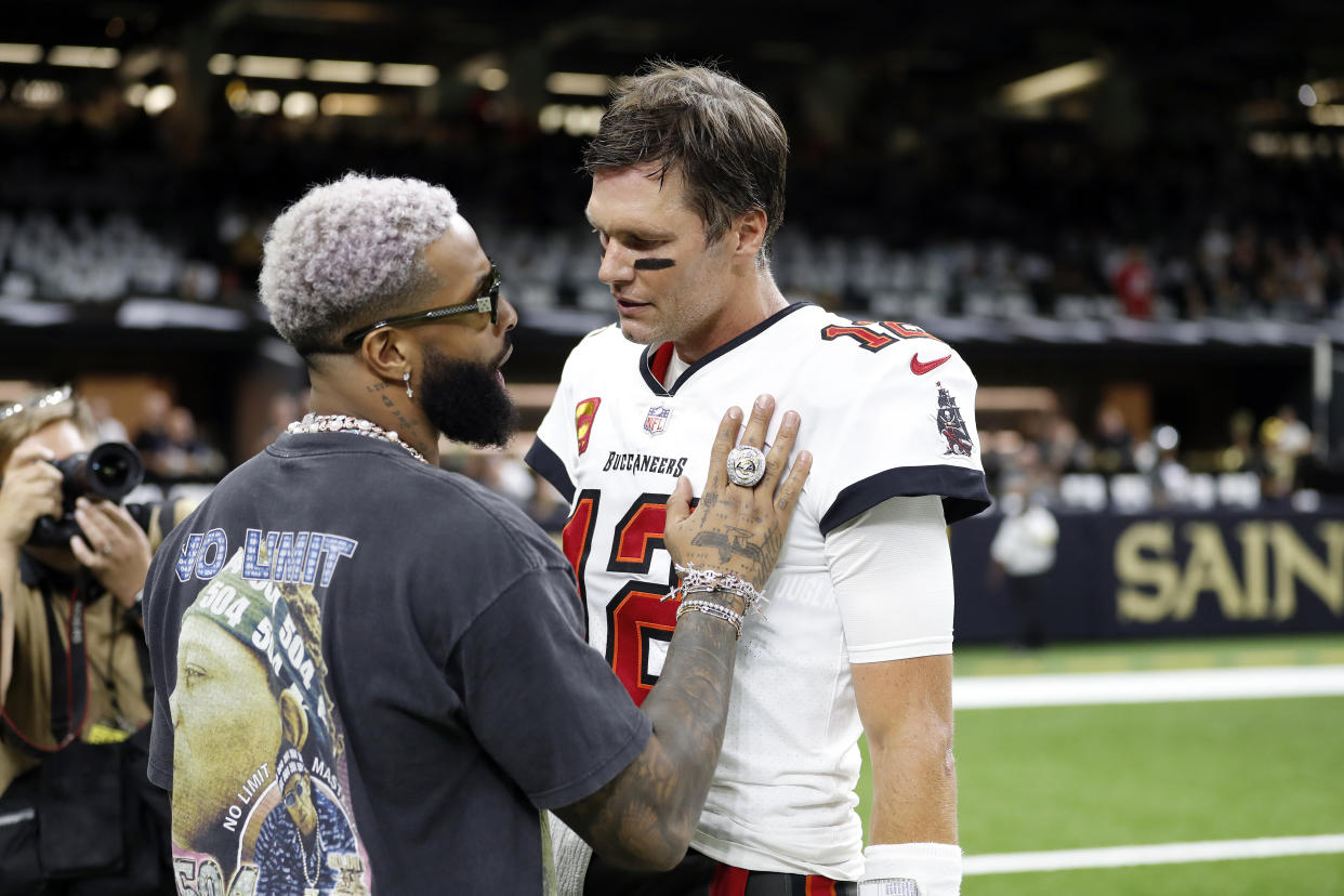 Tampa Bay Buccaneers quarterback Tom Brady (12) speaks with Odell Beckham Jr. before before an NFL football game against the New Orleans Saints, Sunday, Sept. 18, 2022, in New Orleans. (AP Photo/Tyler Kaufman)