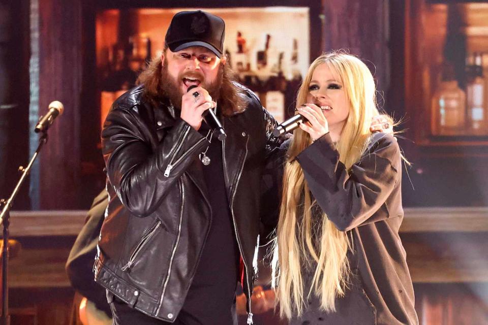 <p>Jason Kempin/Getty</p> Nate Smith and Avril Lavigne perform at the ACM Awards in Frisco, Texas on May 16, 2024