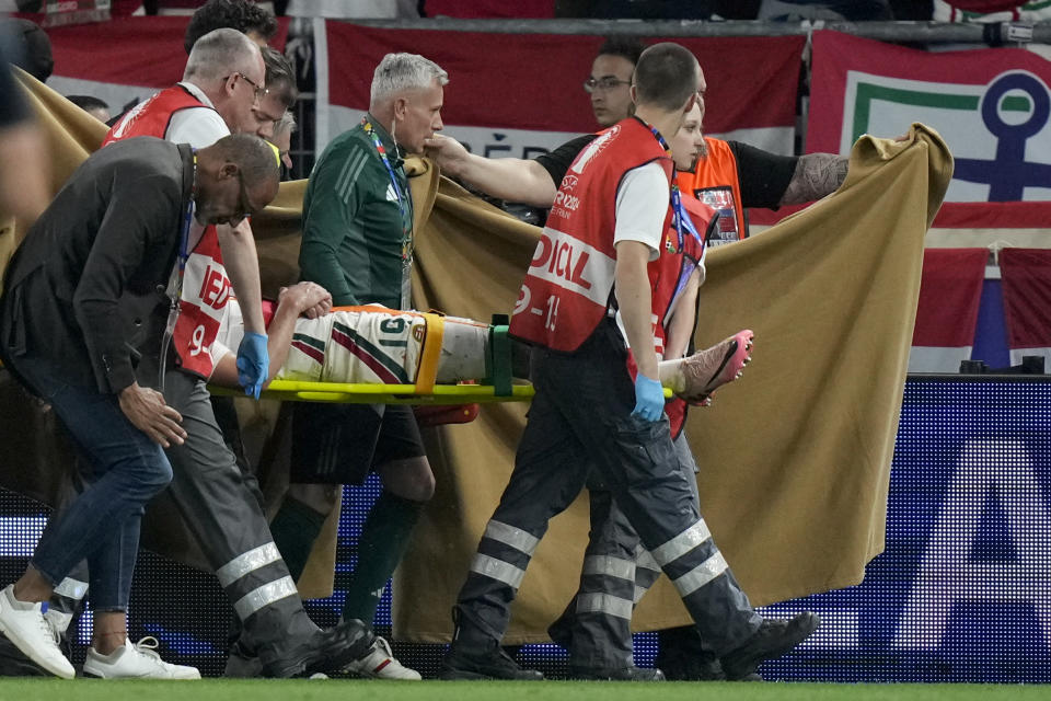 Hungary's Barnabas Varga is strechered out after being injured during a Group A match between Scotland and Hungary at the Euro 2024 soccer tournament in Stuttgart, Germany, Sunday, June 23, 2024. (AP Photo/Matthias Schrader)