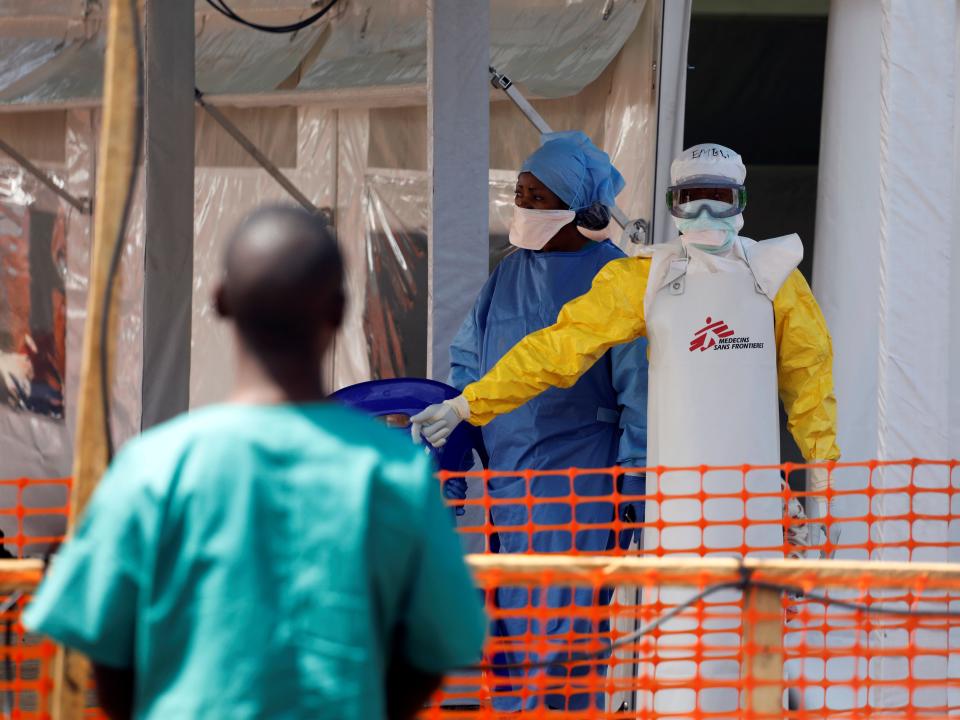 FILE PHOTO: A health worker dressed in a protective suit talks to medical staff at the newly constructed MSF(Doctors Without Borders) Ebola treatment centre in Goma, Democratic Republic of Congo, August 4, 2019. REUTERS/Baz Ratner
