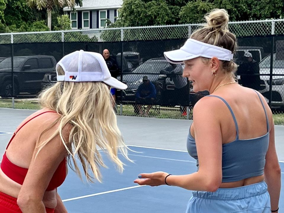 Becca Weissmann (right) and Katrina Glusac talk strategy during a changeover in their match in the National Beach Pop Tennis Tournament at Ron Parker Park.