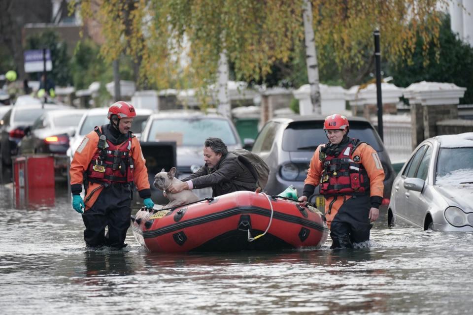 Emergency crews rescue resident and his dog on Belsize Road, Camden  (PA)