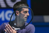 FILE - Defending champion Serbia's Novak Djokovic practices ahead of the Australian Open tennis championship in Melbourne, Australia, Jan. 12, 2022. Weary after two years of some of the harshest COVID-19 border restrictions in the world, many Australians wanted Djokovic kicked out of their country for traveling to the tennis tournament without being vaccinated. But the backdrop to the government's tough line on the defending Australian Open champion and Prime Minister Scott Morrison’s description of the expulsion as a "decision to keep our borders strong" dates to nearly a decade ago. It also shines a light on Australia's complicated, and strongly criticized, immigration and border policies. (AP Photo/Mark Baker, File)