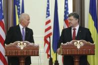 Ukraine's President Petro Poroshenko (R) listens to U.S. Vice President Joe Biden during a news conference in Kiev, November 21, 2014. REUTERS/Valentyn Ogirenko