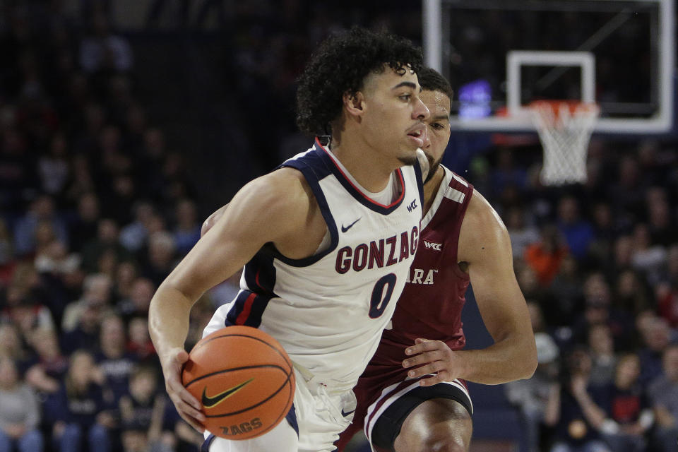 Gonzaga guard Julian Strawther, front, drives while defended by Santa Clara forward Keshawn Justice during the first half of an NCAA college basketball game, Thursday, Feb. 2, 2023, in Spokane, Wash. (AP Photo/Young Kwak)