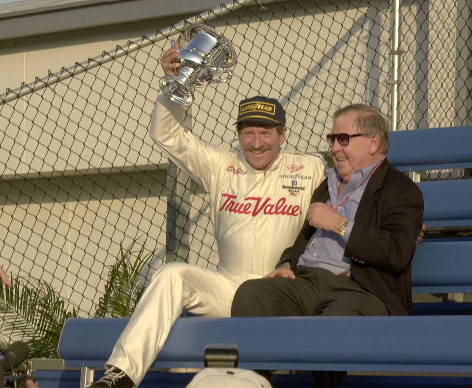 Earnhardt in the Victory Lane bleachers with NASCAR president Bill France Jr., after winning Daytona's IROC race in 2000. It was his 34th and final Daytona win.