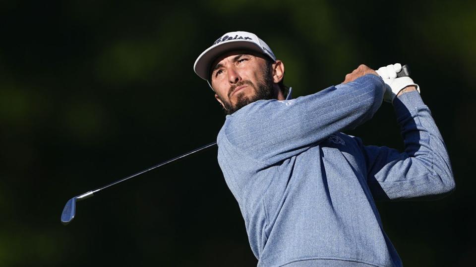 Max Homa watches his tee shot on a golf course at Quail Hollow Club.