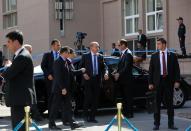 Turkish Prime Minister Recep Tayyip Erdogan, center, is surrounded by his security members outside his office in Ankara, Turkey, Thursday, April 17, 2014. Turkey's parliament looks set to pass a bill that increases the powers and immunities of the country's spy agency. It is the latest in a string of moves critics say is undermining democracy in the country that is a candidate to join the European Union. The bill, expected to be voted on Thursday, gives the National Intelligence Agency greater eavesdropping and operational powers and increases its immunities and abilities to keep tabs on citizens. Journalists publishing classified documents would face prison terms. (AP Photo/Burhan Ozbilici)