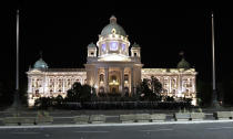 Serbian riot police guard the Serbian parliament building during a protest in Belgrade, Serbia, Friday, July 10 2020. Hundreds of demonstrators tried to storm Serbia's parliament on Friday, clashing with police who fired tear gas during the fourth night of protests against the president's increasingly authoritarian rule. The protests started on Tuesday when President Aleksandar Vucic announced that Belgrade would be placed under a new three-day lockdown following a second wave of confirmed coronavirus infections. (AP Photo/Darko Vojinovic)