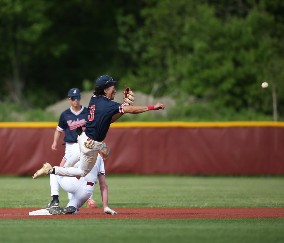 Roy C. Ketcham's Ben Tullo makes a flying throw to first after tagging out Arlington's Ryan Letscher at second during the Section 1 Class AA baseball semifinal versus Arlington on May 23, 2022. 