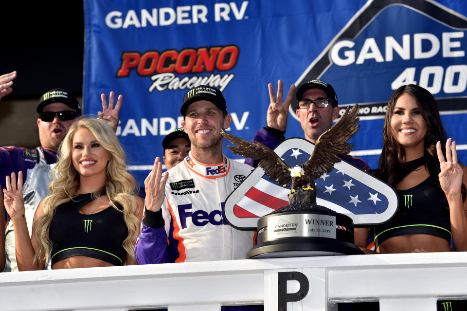 Denny Hamlin, front center, celebrates in Victory Lane after winning a NASCAR Cup Series auto race, Sunday, July 28, 2019, in Long Pond, Pa. (AP Photo/Derik Hamilton)