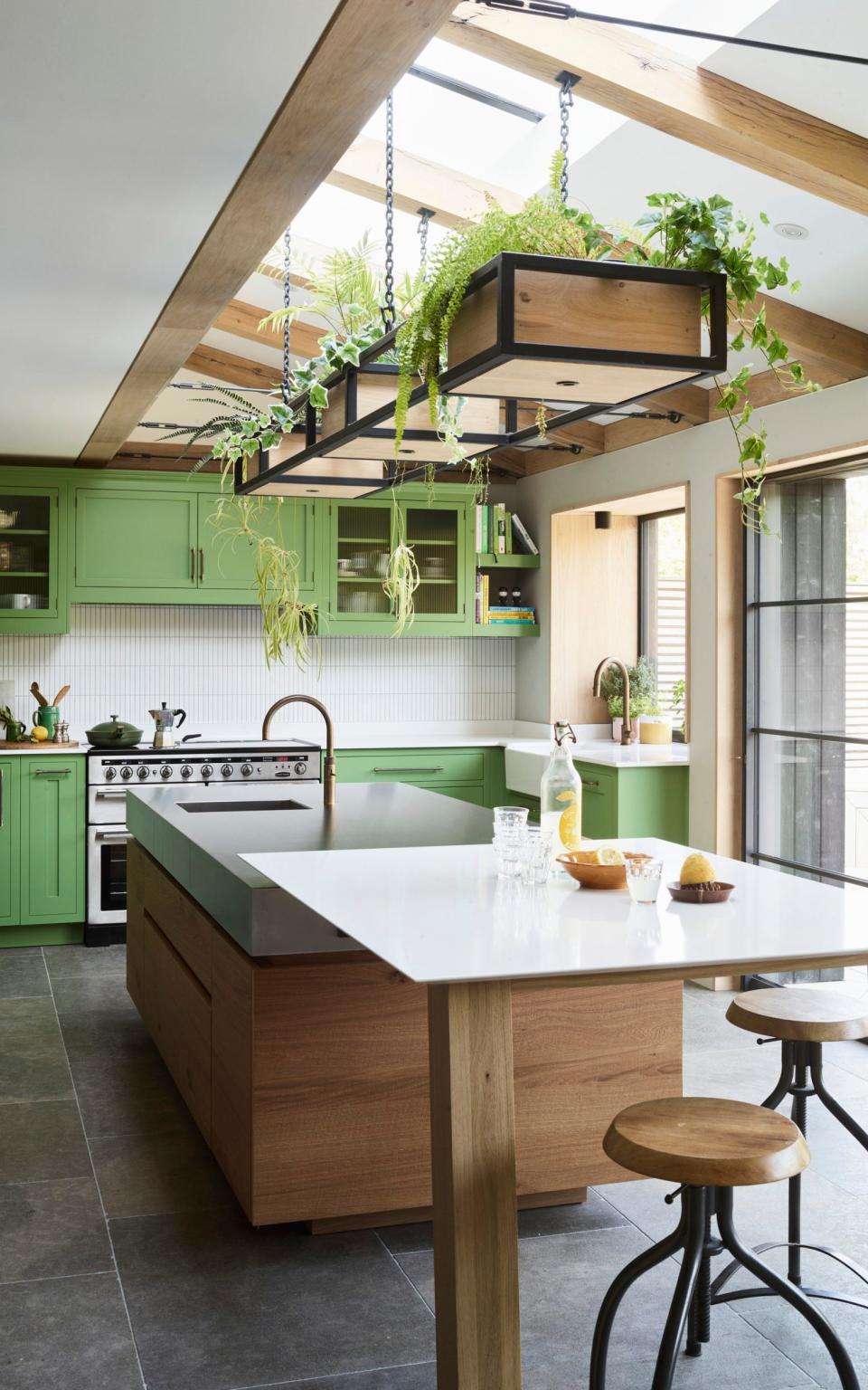 Ben Hawkswell and his wife married country and contemporary aesthetics with pea green cabinets alongside modern, handleless oak doors