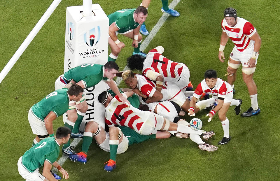 Japan's Fumiaki Tanaka, second right, passes the ball against Ireland's defense during the Rugby World Cup Pool A game at Shizuoka Stadium Ecopa between Japan and Ireland in Shizuoka, Japan, Saturday, Sept. 28, 2019. (Kyodo News via AP)