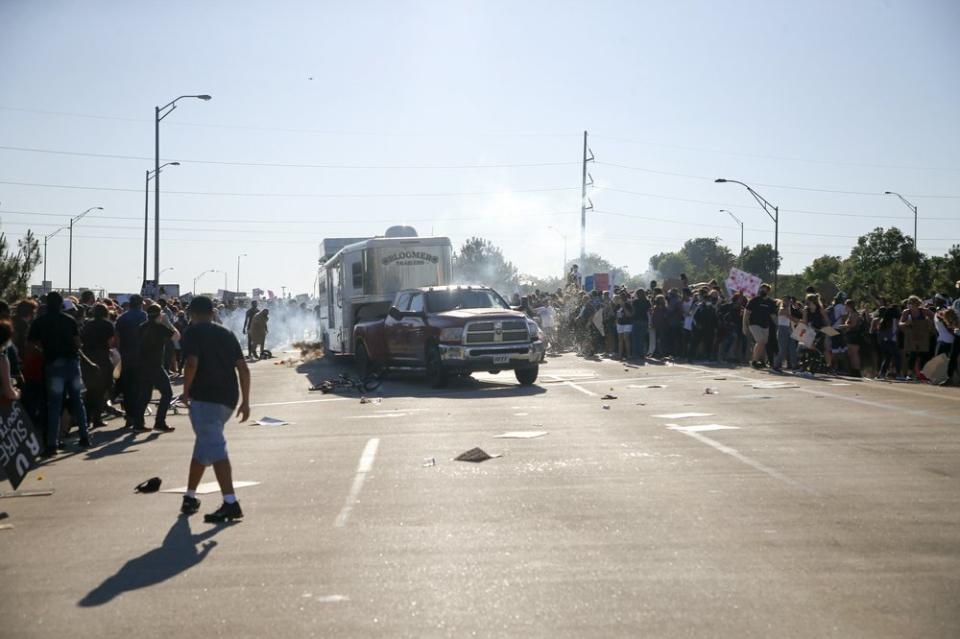 A truck drives through a group of protesters who had shut down Interstate 244 during a rally in Tulsa, Okla., Sunday, May 31, 2020. (Ian Maule/Tulsa World via AP)