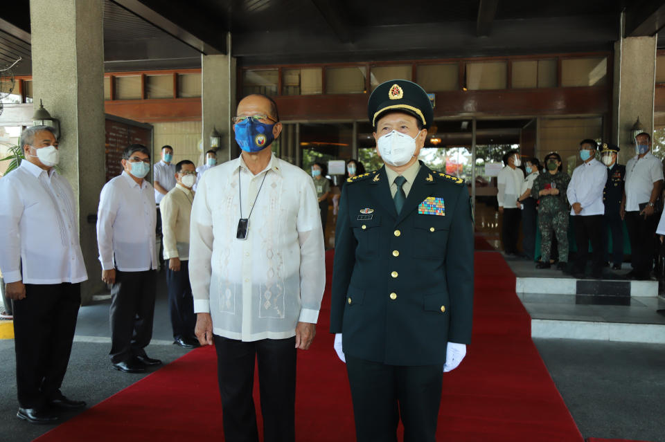 In this handout photo provided by the Department of National Defense Public Affairs Office (PAO), Philippine Defense Secretary Delfin N. Lorenzana, left, stands beside his Chinese counterpart General Wei Fenghe during his visit at the Department of National Defense in Quezon city, Philippines, Friday Sept. 11, 2020. The two discussed ways in responding to the COVID-19 pandemic, revisited the 2004 Philippines-China Memorandum of Understanding (MOU) on Defense Cooperation and also issues on the South China Sea. (Department of National Defense PAO via AP)