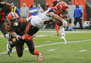 Cincinnati Bengals wide receiver Tyler Boyd (83) dives as Cleveland Browns safety Sheldrick Redwine (29) tackles during the first half of an NFL football game, Sunday, Dec. 8, 2019, in Cleveland. (AP Photo/Ron Schwane)