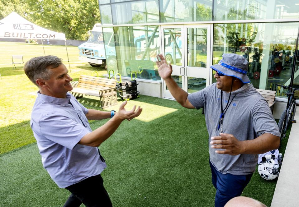 Nick Greer, co-founder of Built Brands, left, and BYU football coach Kalani Sitake greet each other during a press conference at the BYU Student Athlete Building in Provo on Friday, Aug. 13, 2021, where they discussed Built Brands’ name, image and likeness agreement with BYU. | Scott G Winterton, Deseret News