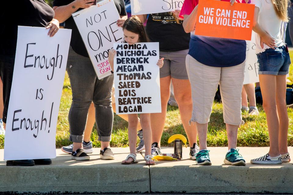 The names of the victims of the Dayton shooting are seen on a sign on Aug. 7, 2019, ahead of a visit from President Donald Trump.