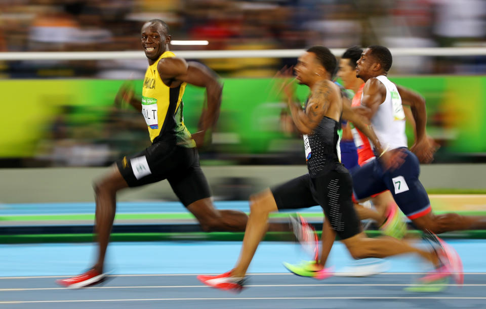 Usain Bolt of Jamaica looks at Andre De Grasse (CAN) of Canada as they compete in the 2016 Rio Olympics, Men's 100m Semifinals at the Olympic Stadium in Rio de Janeiro, Brazil, August 14, 2016.