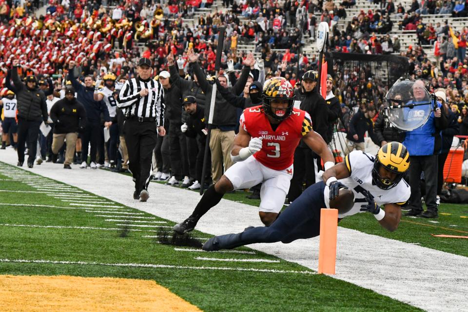 Maryland Terrapins defensive back Nick Cross pushes Michigan Wolverines running back Donovan Edwards out of bounds during the first half Nov. 20, 2021 in College Park, Maryland.