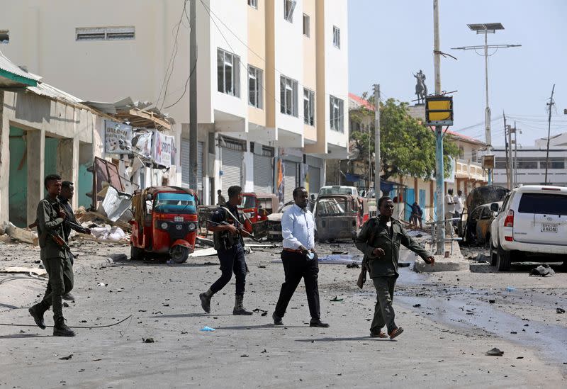 Somali policemen secure the scene of a bomb explosion at the Maka al-Mukarama street in Mogadishu