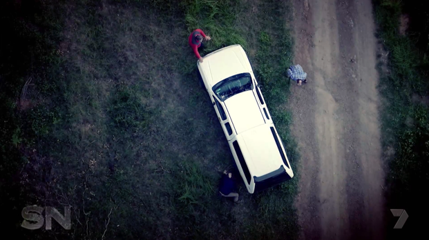 A reenactment showing the confrontation around the car