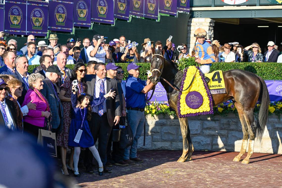 Mike Repole, center, wearing purple tie, celebrates Forte’s victory in the winner’s circle after Friday’s win.