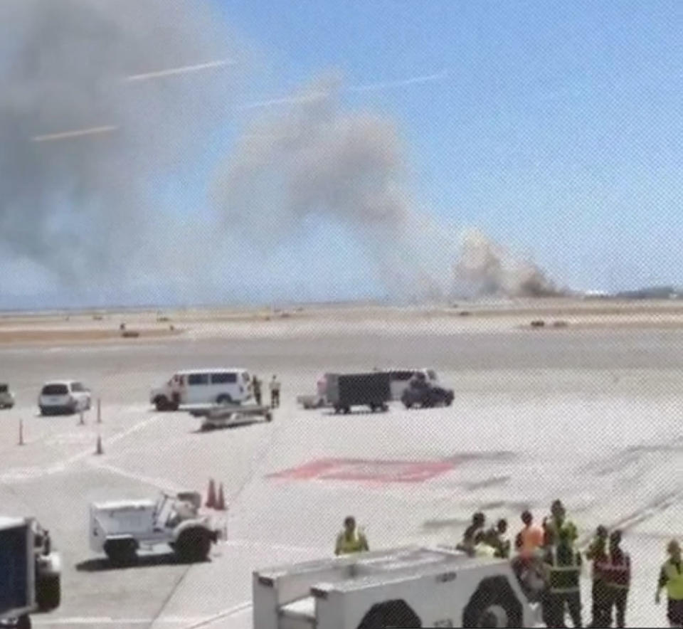 This photo provided by Wei Yeh shows what a federal aviation official says was an Asiana Airlines flight crashing while landing at San Francisco airport on Saturday, July 6, 2013. (AP Photo/Wei Yeh)