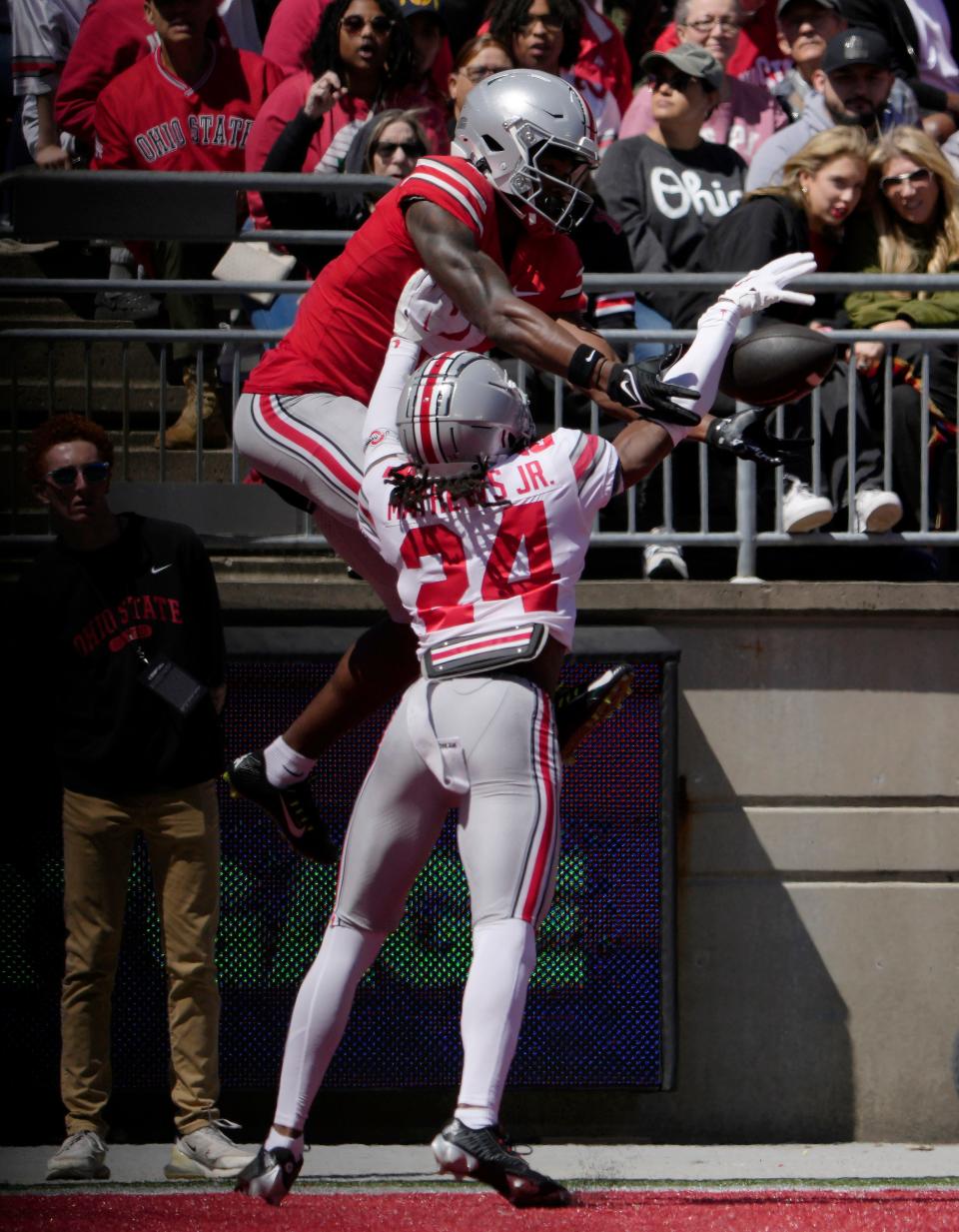 April 13, 2024; Columbus, Ohio, USA; 
Ohio State Buckeyes wide receiver Jeremiah Smith (4) canÕt catch a pass for the scarlet team while defended by cornerback Jermaine Mathews (24) of the grey team during the first half of the LifeSports Spring Game at Ohio Stadium on Saturday.