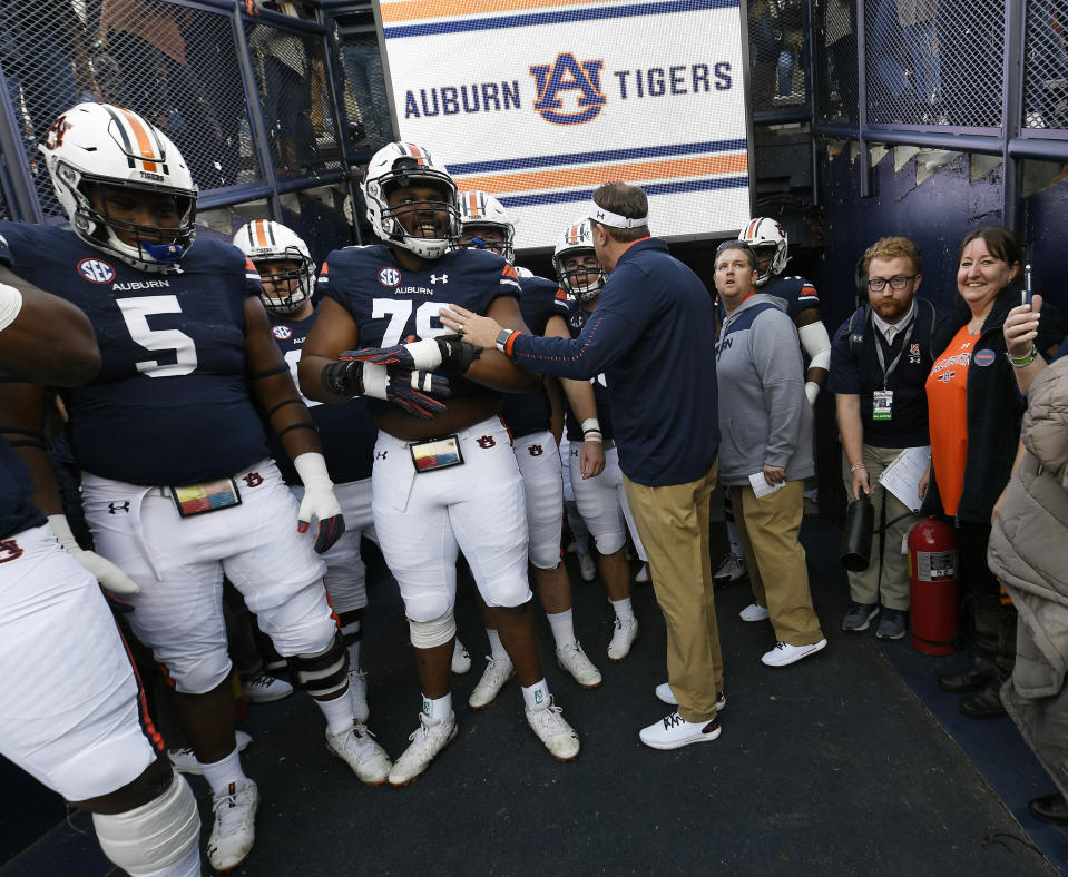 In this Nov. 17, 2018 photo provided by Auburn University Athletics, Dee Ford, right, stands in the team tunnel before a college football game at Jordan-Hare Stadium in Auburn, Ala. An Englishwoman has seen the best and worst that Twitter would have to offer the American football player who shares her name, if he had an account. Dee Ford told the Kansas City Star she was deluged with angry tweets from Kansas City Chiefs fans who thought they were venting at linebacker Dee Ford after his late penalty during Sunday's AFC Championship loss. Oddly enough, she became a fan of the player and sport after being inadvertently tagged in a positive tweet to the player five years ago. She has spoken to the Chiefs' Dee Ford by phone and attended two games — an Auburn home game last fall and a Chiefs game in London in 2015. (Todd Van Emst/Auburn University Athletics via AP)