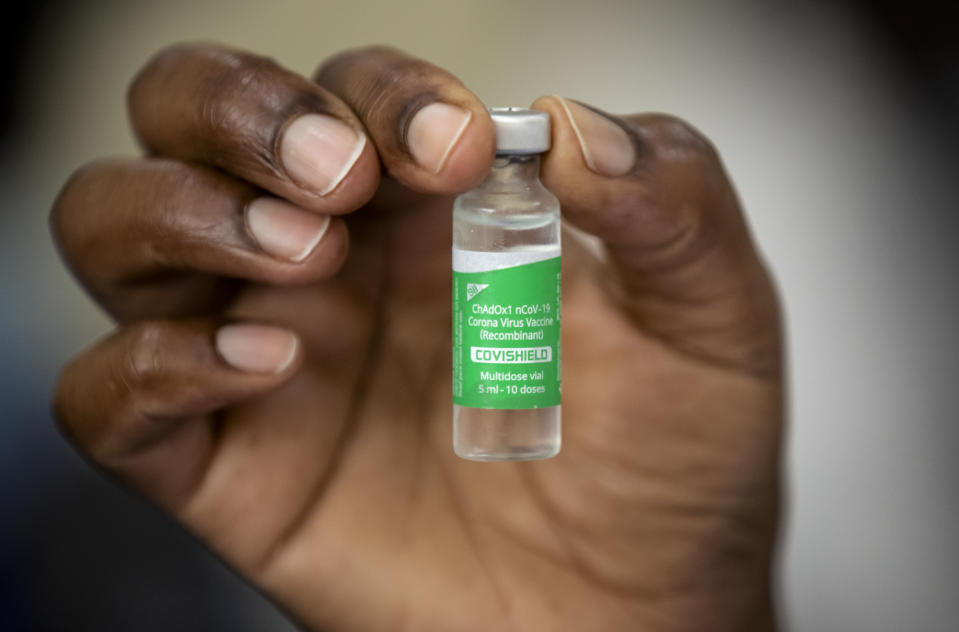 A nurse holds a vial of AstraZeneca COVID-19 vaccine manufactured by the Serum Institute of India and provided through the global COVAX initiative, at Kenyatta National Hospital in Nairobi, Kenya Friday, March 5, 2021. Urgent calls for COVID-19 vaccine fairness rang through African countries on Friday as more welcomed or rolled out doses from the global COVAX initiative, with officials acutely aware their continent needs much more. (AP Photo/Ben Curtis)