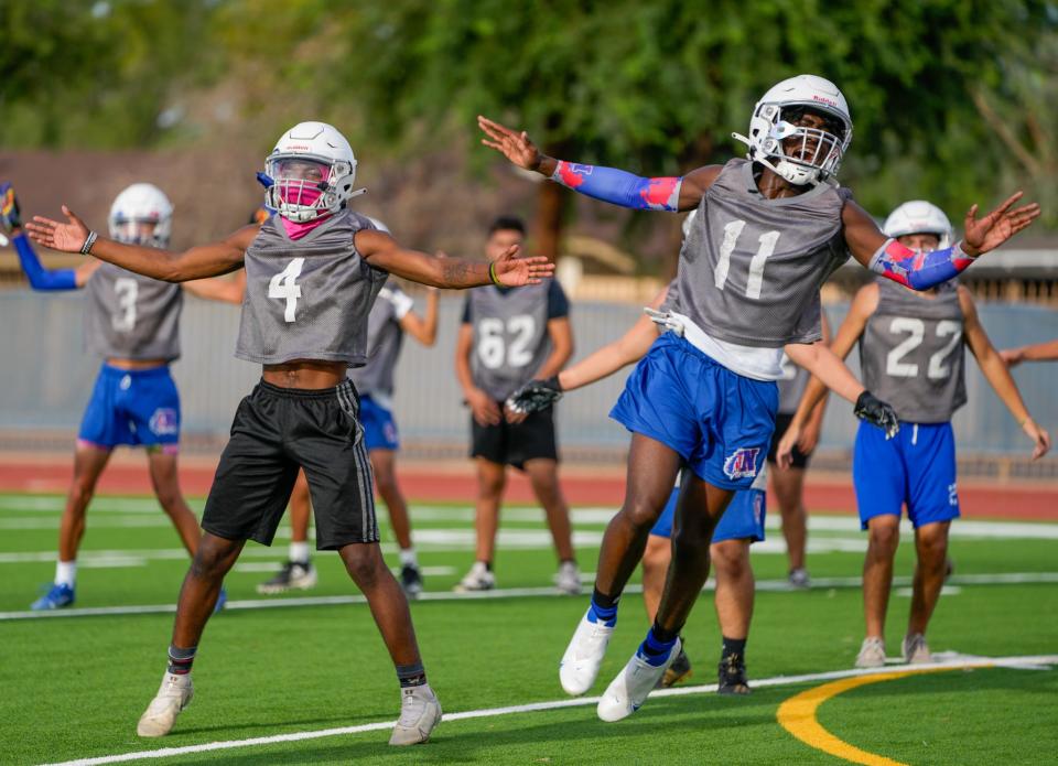 Aug. 9, 2022; Phoenix, Ariz., U.S.; Sophomore wide receiver Ezy Brown (11) leads warm ups during practice at North High School in Phoenix.