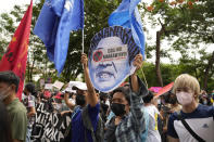 A protester holds a slogan that reads, "Return what you stole," during a rally in front of the office of the Commission on Elections as they question legitimacy of the results of the presidential elections in Manila, Philippines on Tuesday May 10, 2022. The namesake son of late Philippine dictator Ferdinand Marcos appeared to have been elected Philippine president by a landslide in an astonishing reversal of the 1986 "People Power" pro-democracy revolt that booted his father into global infamy. (AP Photo/Aaron Favila)