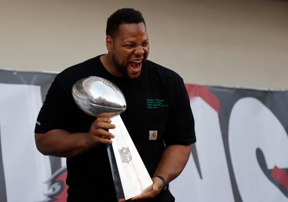 Tampa Bay Buccaneers defensive end Ndamukong Suh holds the Vince Lombardi Trophy during a boat parade to celebrate victory in Super Bowl LV against the Kansas City Chiefs, Feb. 10, 2021 in Tampa, Fla.