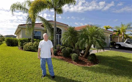 Robert Davidson stands in front of the home he purchased in 2011 in a Naples, Florida golf course community September 21, 2013. REUTERS/Joe Skipper