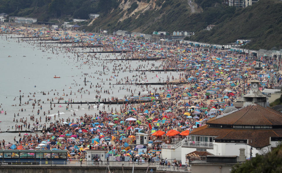 People enjoy the hot weather at Bournemouth beach in Dorset. (Photo by Andrew Matthews/PA Images via Getty Images)