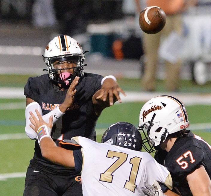 Cathedral Prep junior Carter Barnes, left, is protected by teammate Benjamin Brzezinski, right, as he throws against Butler on Oct. 15, 2021, at Dollinger Field in Erie.