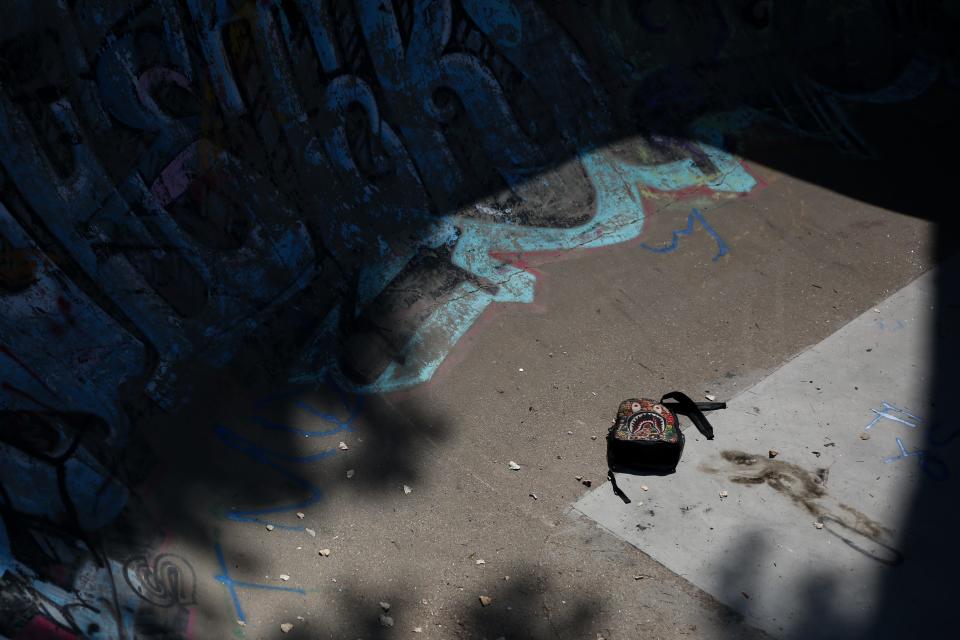 A discarded backpack lays at the bottom of the Pine Ridge skatepark bowl on Wednesday, Aug. 23, 2023.