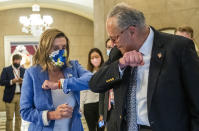 House Speaker Nancy Pelosi of Calif., gives Senate Minority Leader Chuck Schumer of N.Y., an elbow bump as Schumer leaves following a meeting at the Capitol with White House chief of staff Mark Meadows and Treasury Secretary Steven Mnuchin on a COVID-19 relief bill, Saturday, Aug. 1, 2020, in Washington. (AP Photo/Manuel Balce Ceneta)