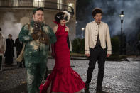 This image released by Disney shows Paul Walter Hauser, Emma Stone and Joel Fry in a scene from "Cruella." Costumes for the film were designed by Oscar winning designer Jenny Beavan. (Laurie Sparham/Disney via AP)