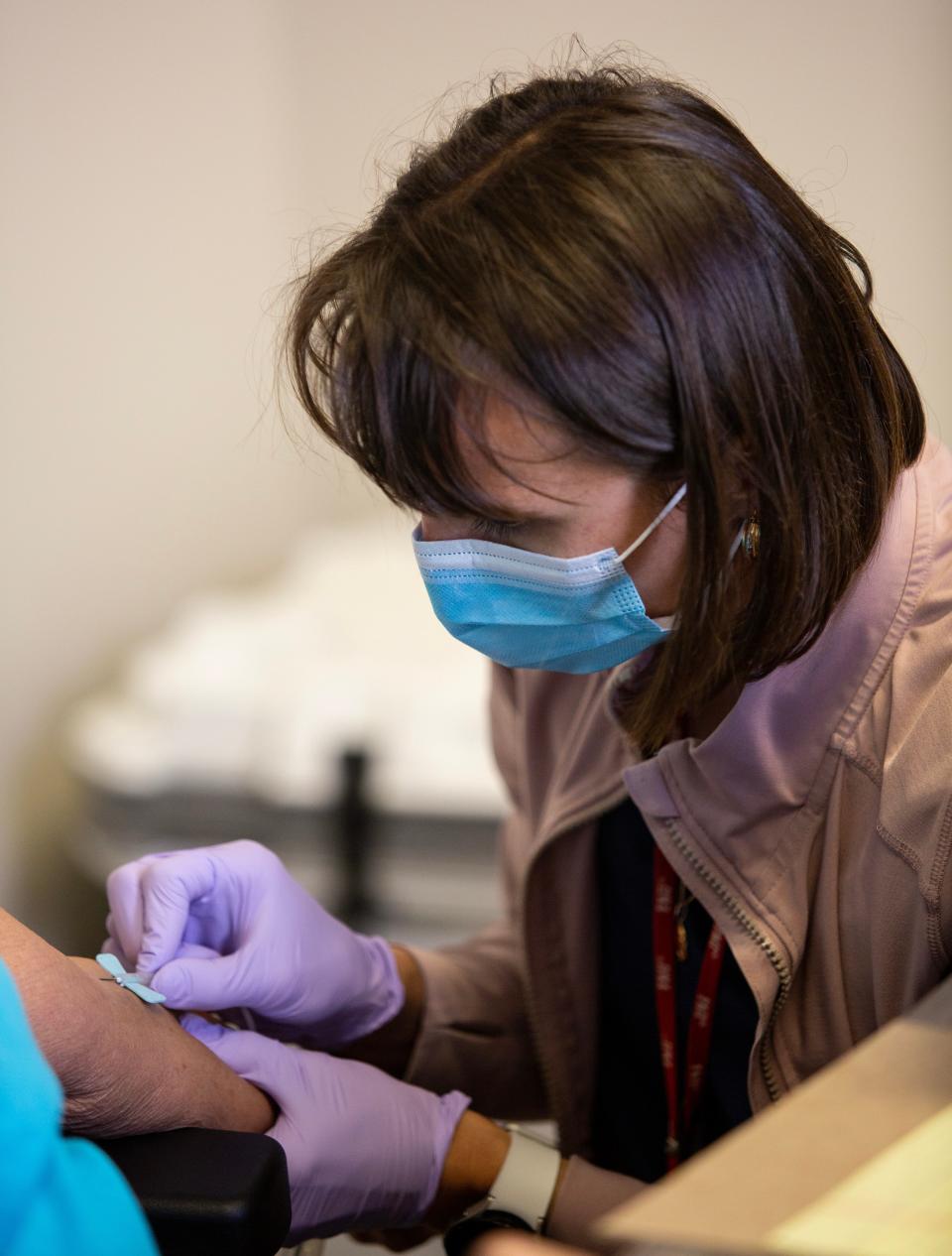 Judyta Kociolek takes a blood sample on from one of the research study participants Wednesday, Dec. 13, 2023, in Cape Coral. Kociolek is the Director of Clinical Research Unit Operations at Florida Atlantic University, and she is collecting samples for a study for the Department of Health about the potential health effects of algae blooms.