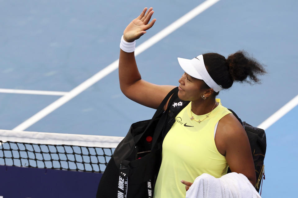 FILE - Naomi Osaka of Japan waves to the crowd after she lost her match against Karolina Pliskova of the Czech Republic during the Brisbane International tennis tournament in Brisbane, Australia, on Jan. 3, 2024. The first 15-day Australian Open sets to start Sunday morning, Jan. 14. (AP Photo/Tertius Pickard, File)