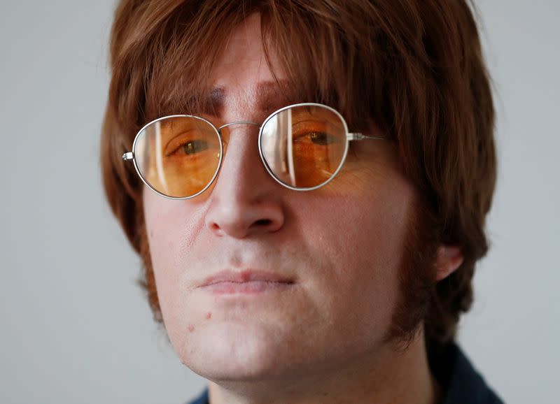 Javier Parisi, who impersonates late former Beatle John Lennon, poses for a picture after an interview with Reuters, in Lanus, on the outskirts of Buenos Aires