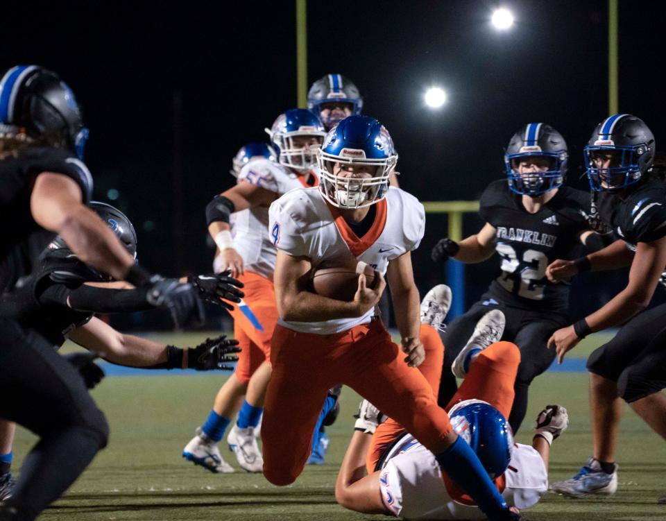 Whiteland Warrior running back Peyton Emberton (4) jukes Franklin Grizzly Cub Beau Baker (21) on Friday, Nov. 4, 2022 in Franklin. 