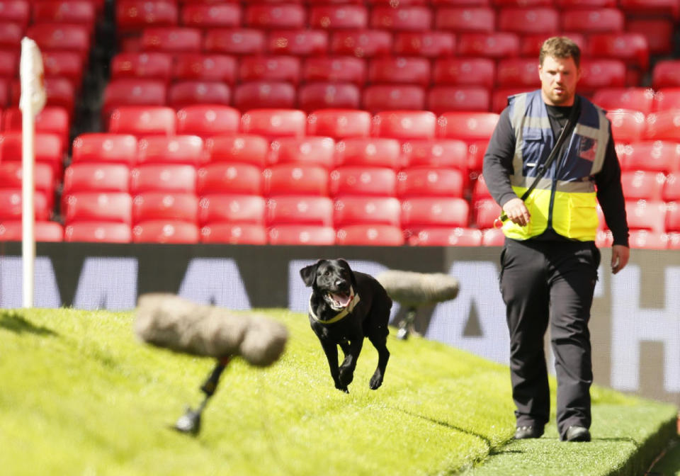 Police use sniffer dogs as fans are evacuated from Old Trafford stadium before the Barclays Premier League match between Manchester United and AFC Bournemouth in Manchester, England, on May 15, 2016. (Jason Cairnduff/Livepic/Action Images via Reuters)