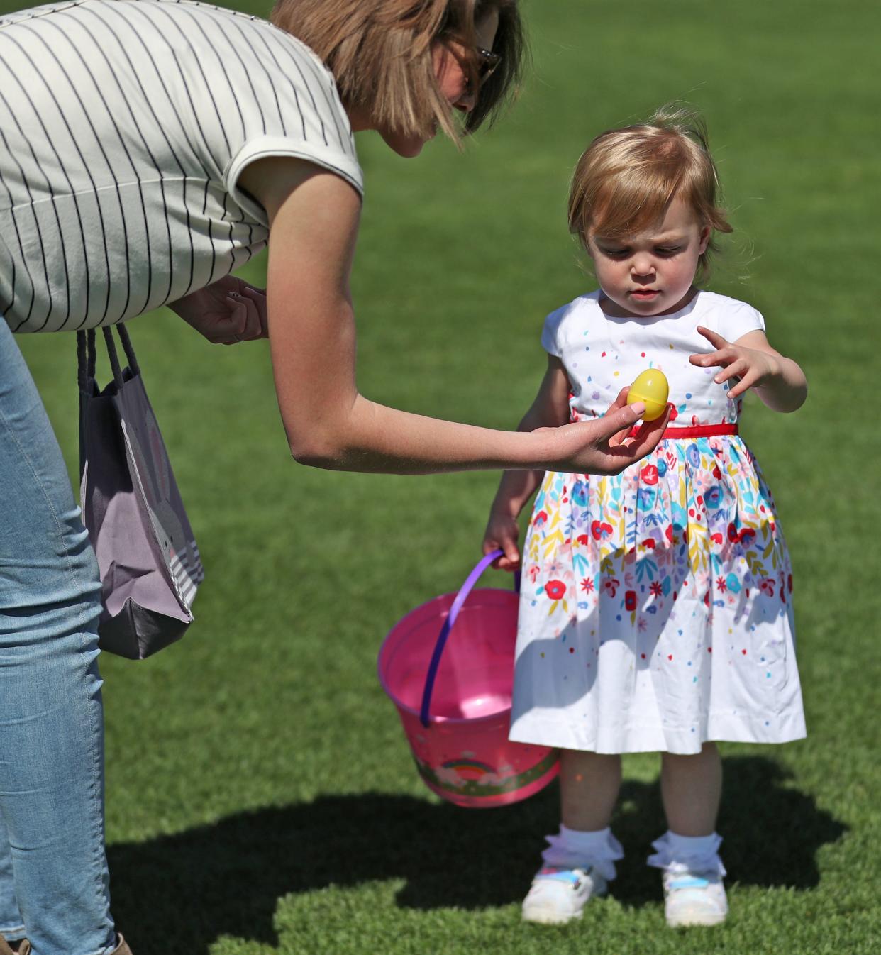 Kylie Kinder shows one of the eggs her daughter Lilly Kinder found during an Easter egg hunt in the outfield at Victory Field, Sunday, April  21, 2019.