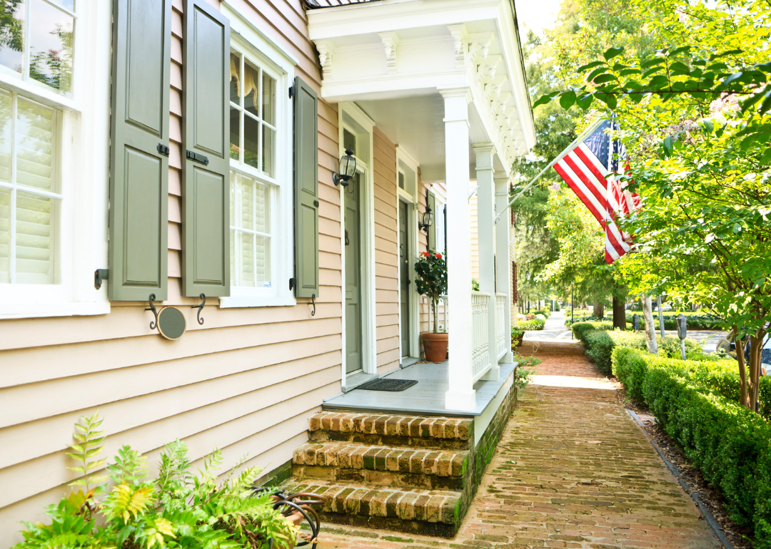 A historic home with an American flag.