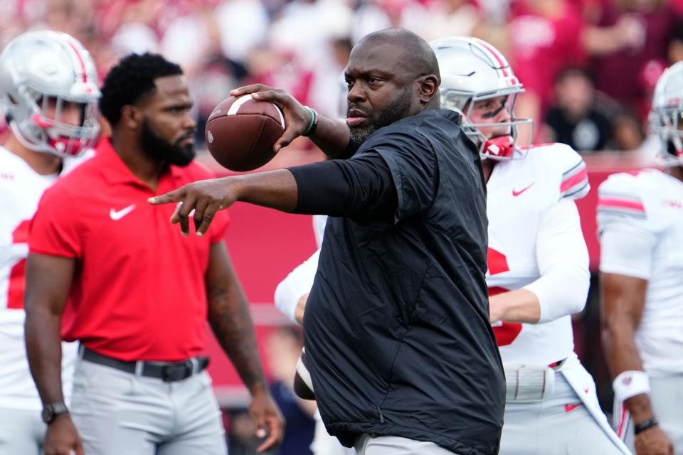 Sep 2, 2023; Bloomington, Indiana, USA; Ohio State Buckeyes running backs coach Tony Alford throws during warm ups prior to the NCAA football game at Indiana University Memorial Stadium. Ohio State won 23-3.