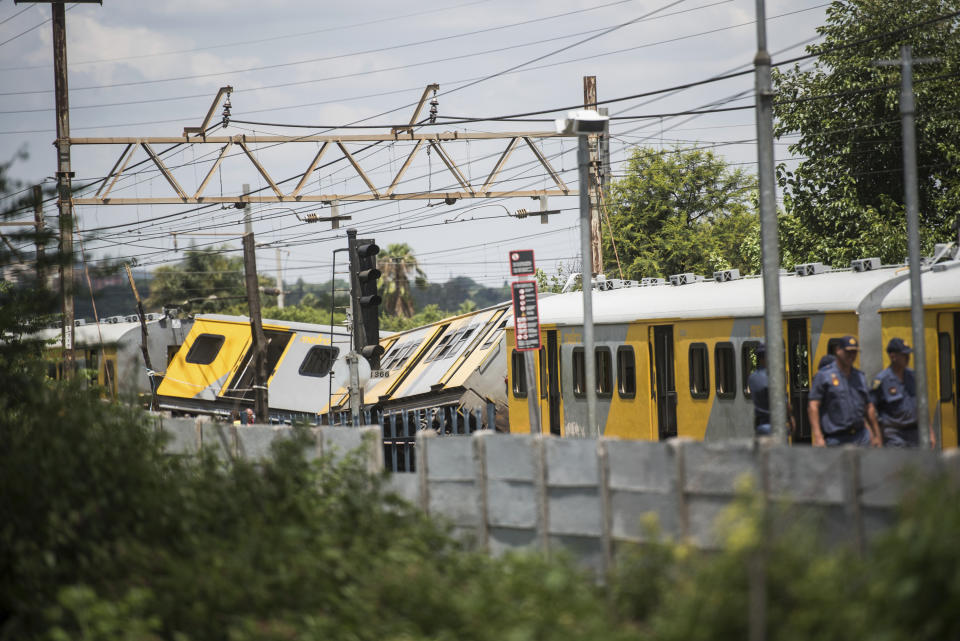 Train carriages are damaged after a train collision at the Mountainview station in Pretoria, South Africa, Tuesday, Jan. 8, 2019. Authorities say that the accident in the capital has killed three people and injured more than 200. (AP Photo)