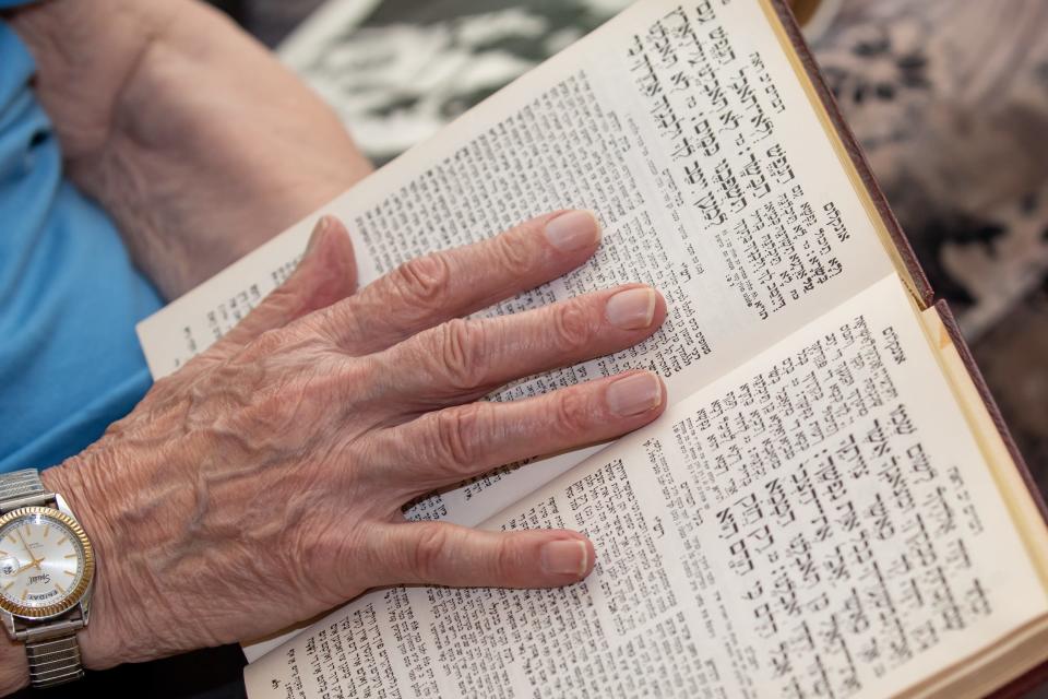Ernie Gross, a holocaust survivor living in Philadelphia, leafs through the pages of a Siddur prayer book, as he shares his story Friday, July 31, 2020.